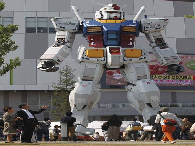 Tokyo: Visitors look at a full-size model of Japan’s robot animation character “Gundam” standing in front of a shopping mall. The 18-meter-tall “Gundam” was installed to promote its entertainment facility “Gundam Front Tokyo”, which opened last month.–Reuters
