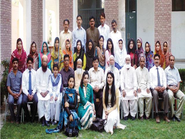 SAHIWAL: Govt Postgraduate College Principal Dr Anwaar and Dr Khalid Farooq with teachers and students at a welcome party.–Staff photo