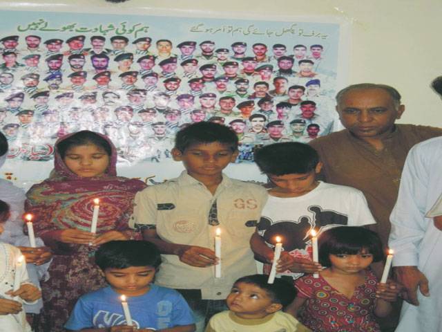 SHEIKHUPURA: Children holding candles during a prayers service at Dorothea Centre for Special Children.–Staff photo