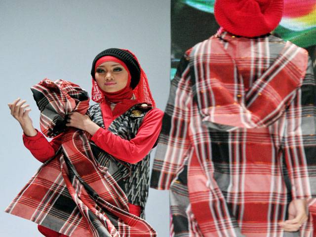  Models display dress designs during Indonesia Islamic fashion fair 2013