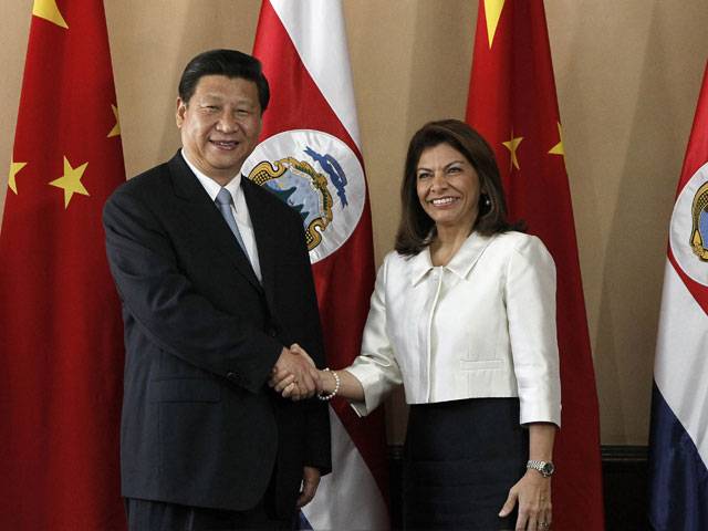 China's President Xi Jinping greets Costa Rica's President Laura Chinchilla during a bilateral meeting