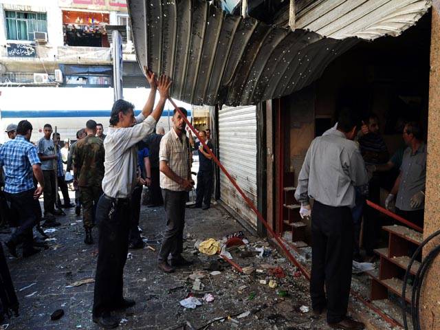 Twin blasts kill at least 14 in central Damascus