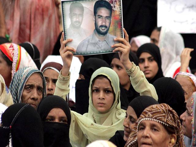 Women hold a demonstration rally against gang war in Karachi