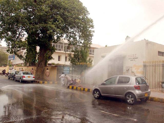 Police use water canon to disperse protesters during a demonstration against nonpayment of salaries in Karachi