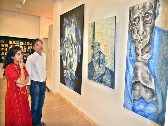 Visitors keenly viewing the art work during a Degree Show of Fine Arts Department, Kinnaird College for Women