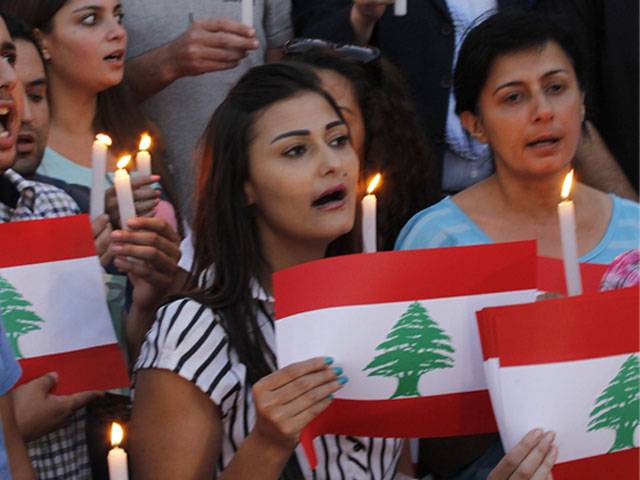 People hold candles during a vigil in solidarity with the Lebanese Army