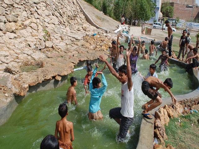 Youngsters bathing in water pound to get relief from sizzling hot weather