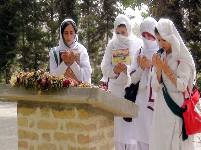Students of SBKW University offer dua at site of recent bomb attack on a bus of the university in Quetta