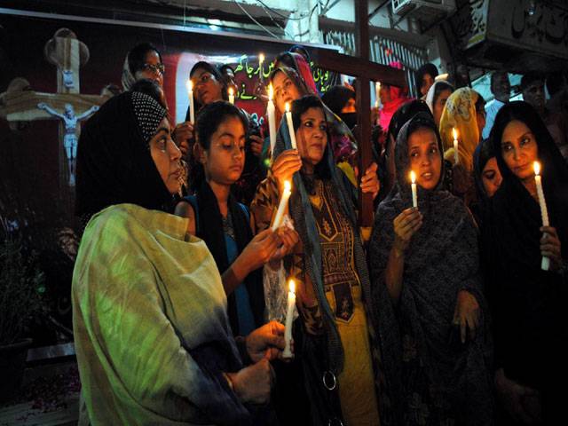 Women lit the candle to pay homage to the victims of Kohati Gate Church Peshawar