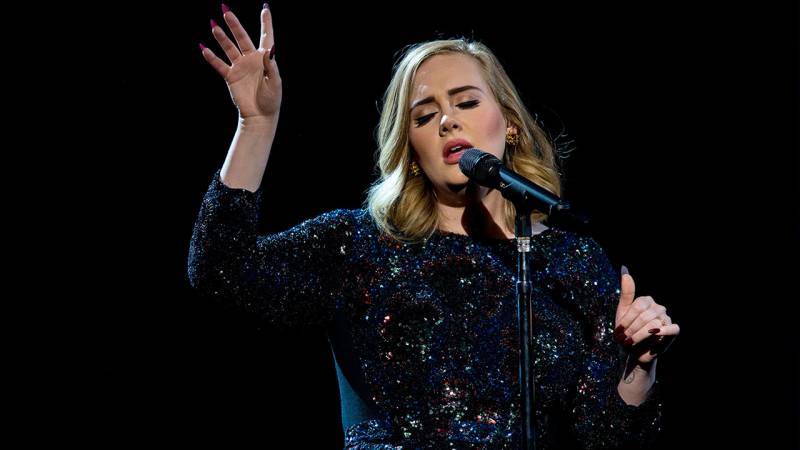 Adele makes emotional visit to London apartment tower fire, offers hugs and support