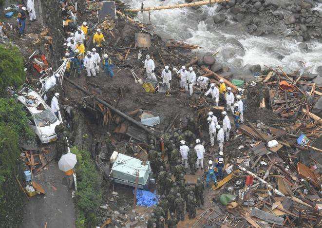 Japan rescuers dig through rubble as rain goes on, at least six dead 