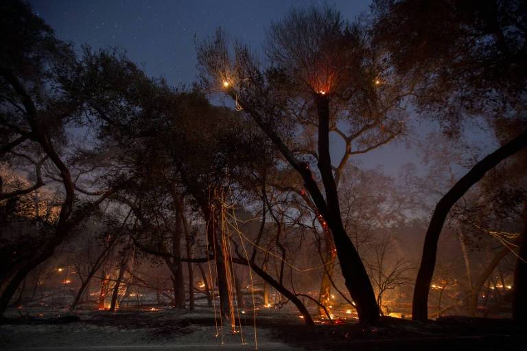 As winds relent, scorched California hopes for fire relief