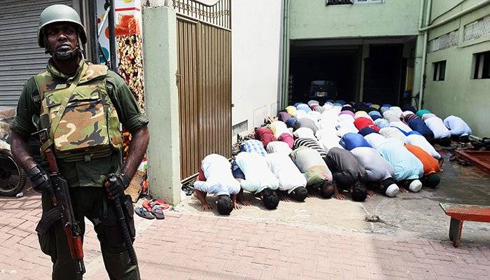 Muslims pray under military protection in Sri Lanka after riots