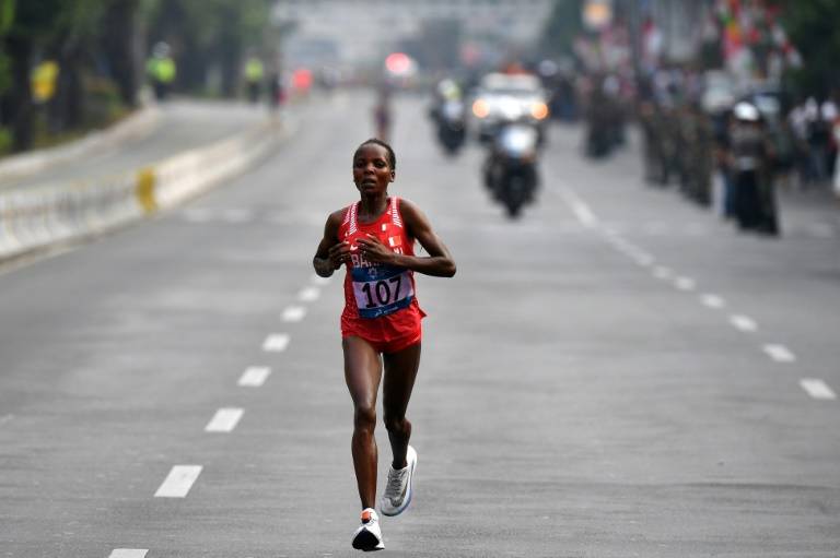 Chelimo blasts heat, pollution after marathon gold 