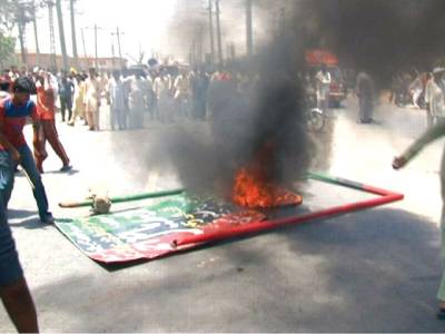 A protest turns violent. Irked people set a PPP leader’s poster on fire in Faisalabad.–Staff photo