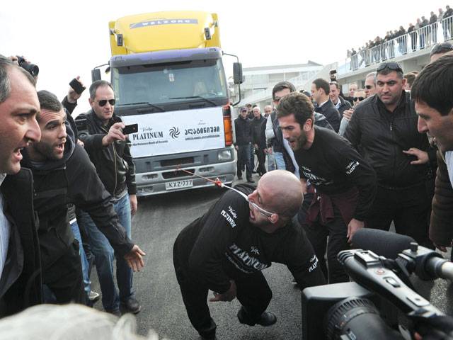 Georgian strongman pulls eight-tonne truck with ear