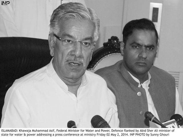 Islamabad: Khawaja Muhammad Asif, federal Minister for Water and Power, Defence flanked by Abid Sher Ali minister of state for water & power addressing a press conference at ministery Friday 02 May 2, 2014. INP Photo by Sunny Ghouri