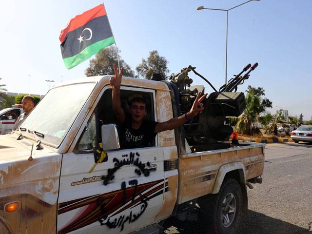 Islamist fighers coalition stand guard at the enterance of Tripoli airport in Libya