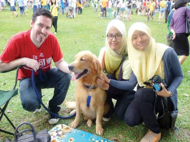 Malaysia Islamic authorities probe ‘dog patting’ event
