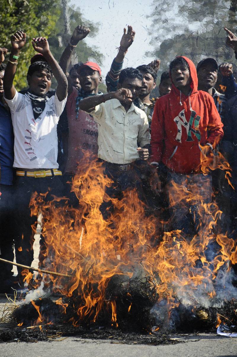  Indian demonstrators shout slogans and burn effigies