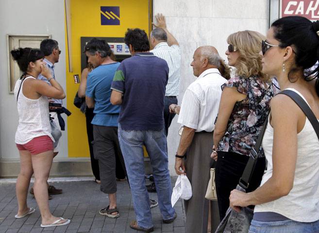People line up to withdraw cash