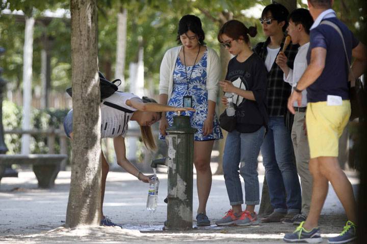 Tourists collect water