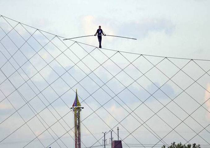 Daredevil Nik walks high wire above racetrack