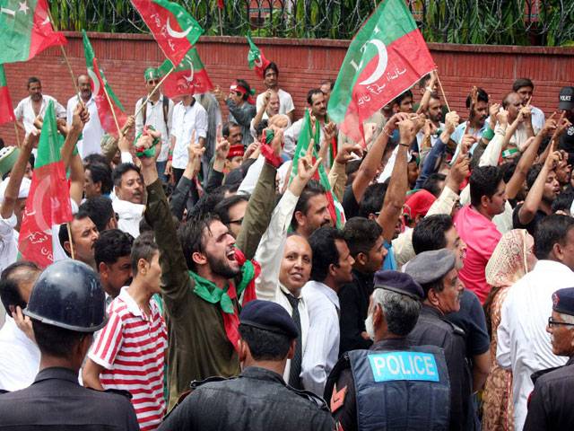 PTI Activists chant slogans before announcement the election tribunal in Lahore