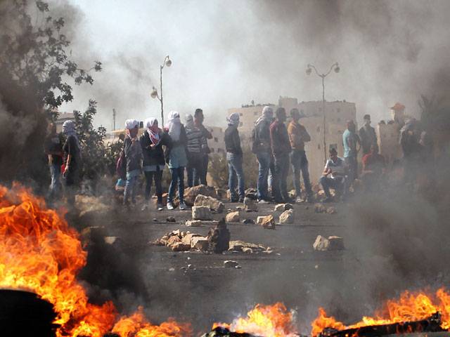 Protesters set fire to tires during clashes with Israeli security forces Beit El