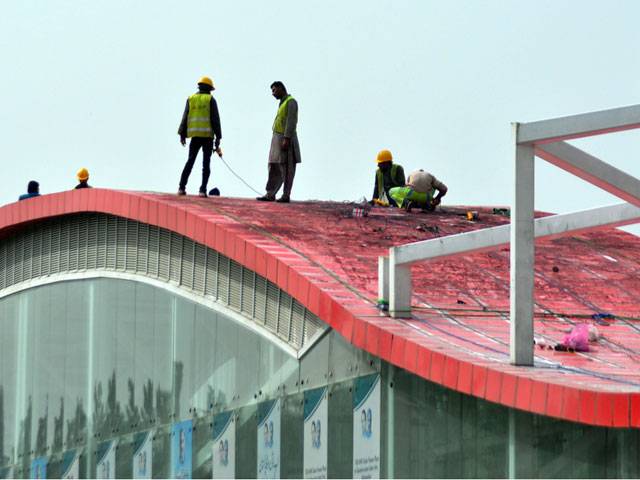 Workers busy in repairing a metro bus station