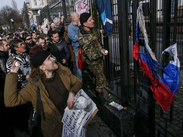 Protesters throw eggs towards a building of the Russian embassy 
