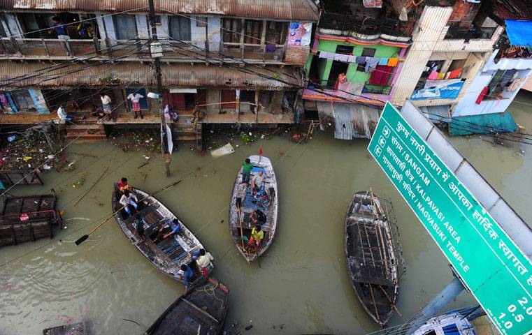 Indian flood-affected residents use boats