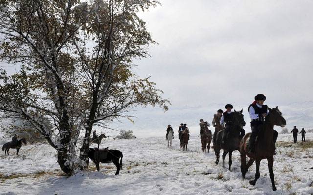  Kyrgyz horsemen perform during the traditional folk festival at the Burana