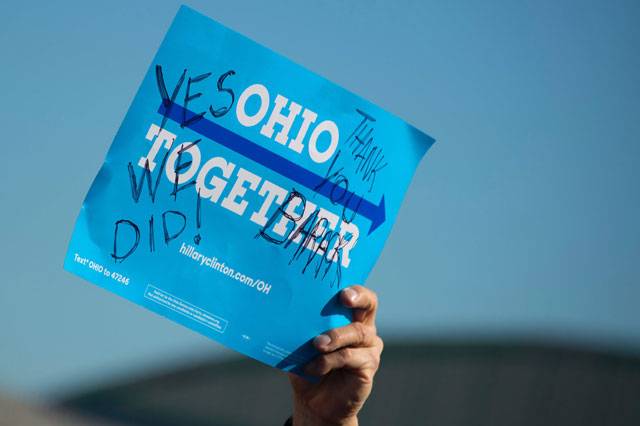  Supporter holds up a placard as Barack Obama speaks at a Hillary for America campaign
