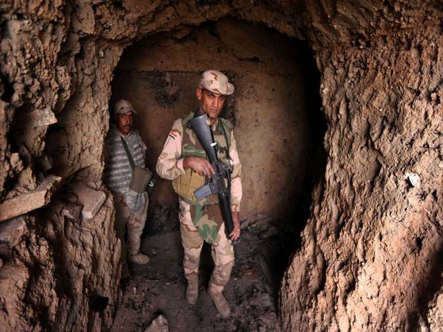 Iraq forces inspect a tunnel in the vicinity of Saint Barbara Church