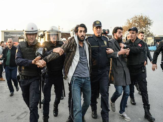  Police officers detain protesters in Istanbul