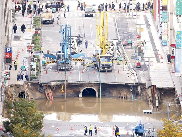 Japan crews work ‘around the clock’ to fill giant sinkhole