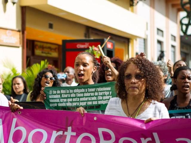 People take part in the march demanding Dominican President to review the penal code
