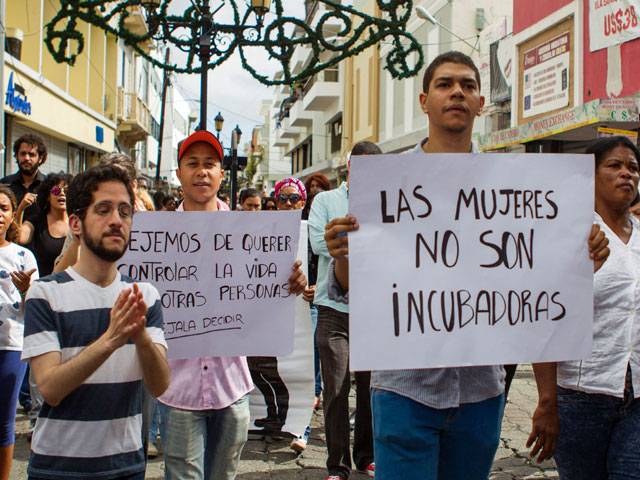 People take part in the march demanding Dominican President to review the penal code