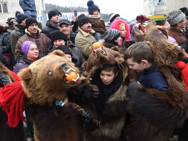 Children wearing bear skins dance from Christmas until after New Year