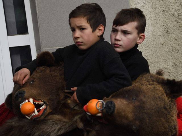 Children wearing bear skins dance from Christmas until after New Year