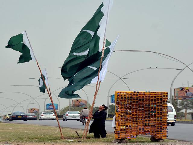  Natioinal flag on his road side on the eve of Pakistan Day