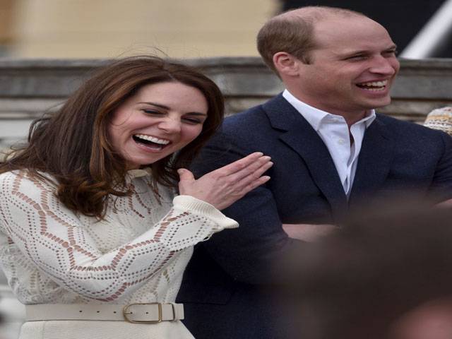 Britain's Prince William and his wife laugh as they host a special Garden Party in London