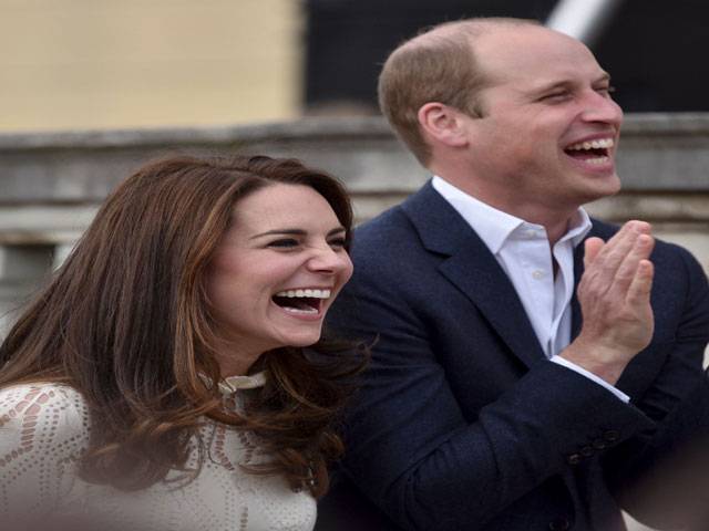 Britain's Prince William and his wife laugh as they host a special Garden Party in London