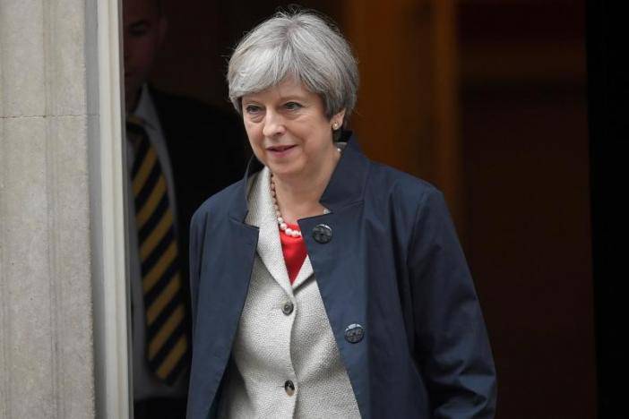 May finds it lonely at the top, but battles on - for now