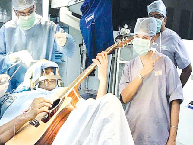 Man who played guitar during surgery makes recovery