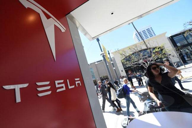 Tesla begins delivering 'Model 3' car for the masses