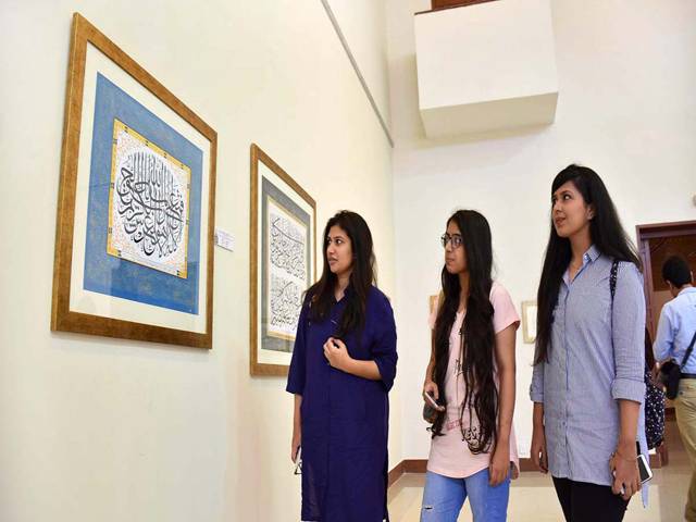  Visitors taking keen interest in displayed artwork at International Calligraphy Exhibition in Islamabad