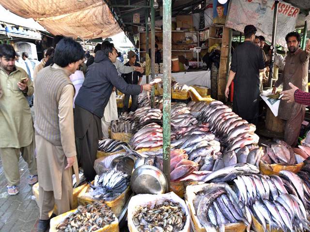 People purchasing fishes at a stall at Rawalpindi