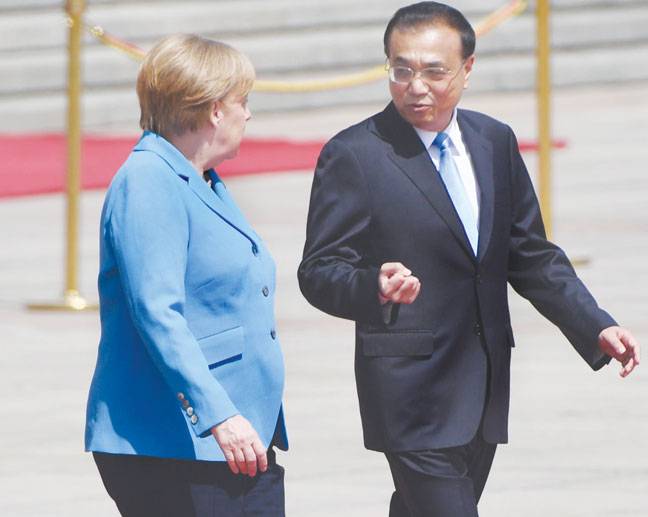 Merkel, Chinese premier defend Iran deal, free trade